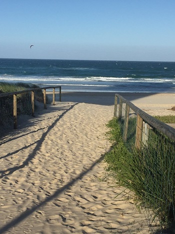 Image of a sand track leading onto the beach at Coolangatta with welcome ocean ahead of track in the near distance
